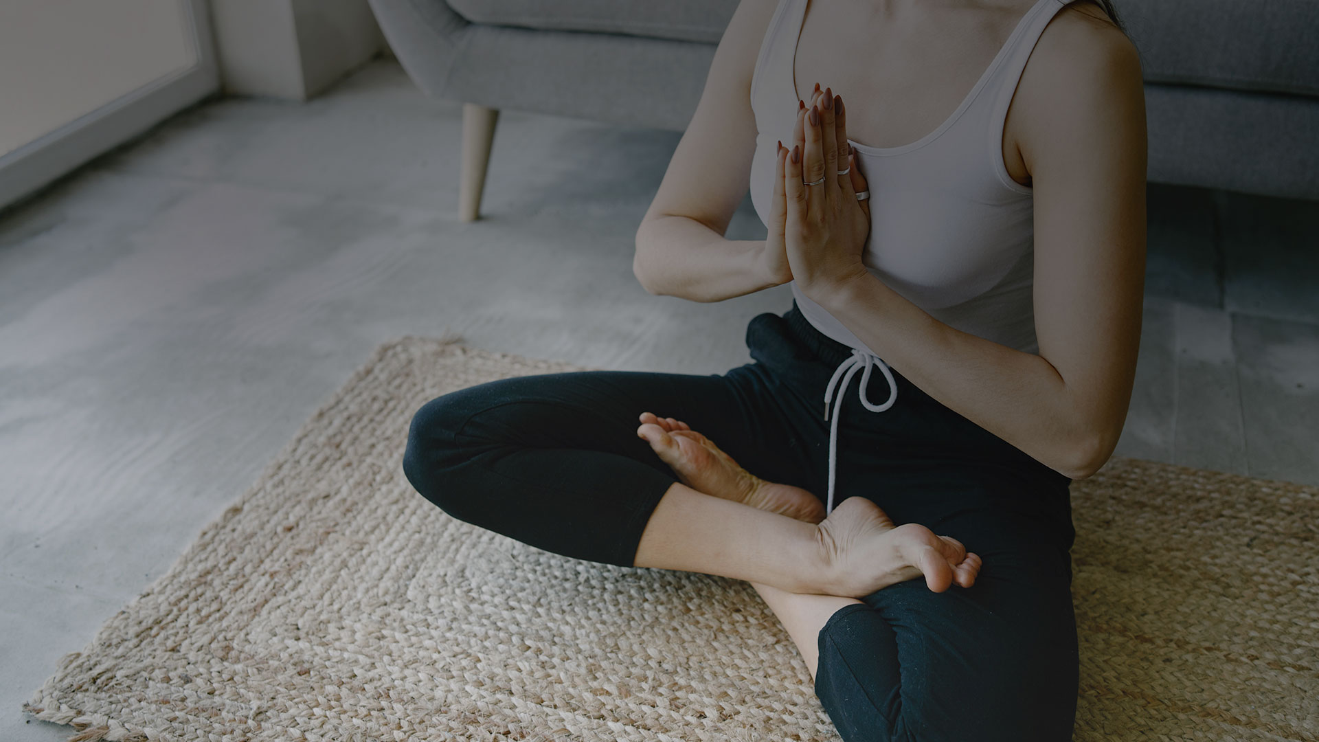 A woman doing yoga in her living room