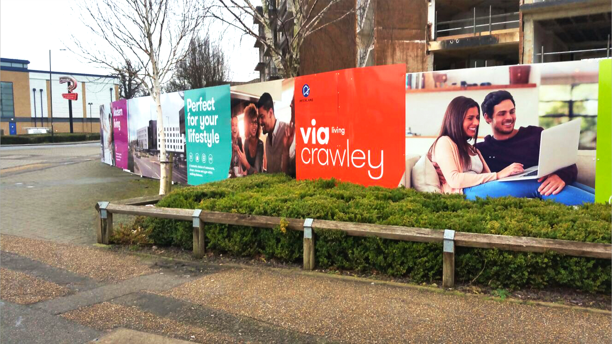 Interland hoarding panels showing lifestyle imagery and brightly coloured panels with large call to actions