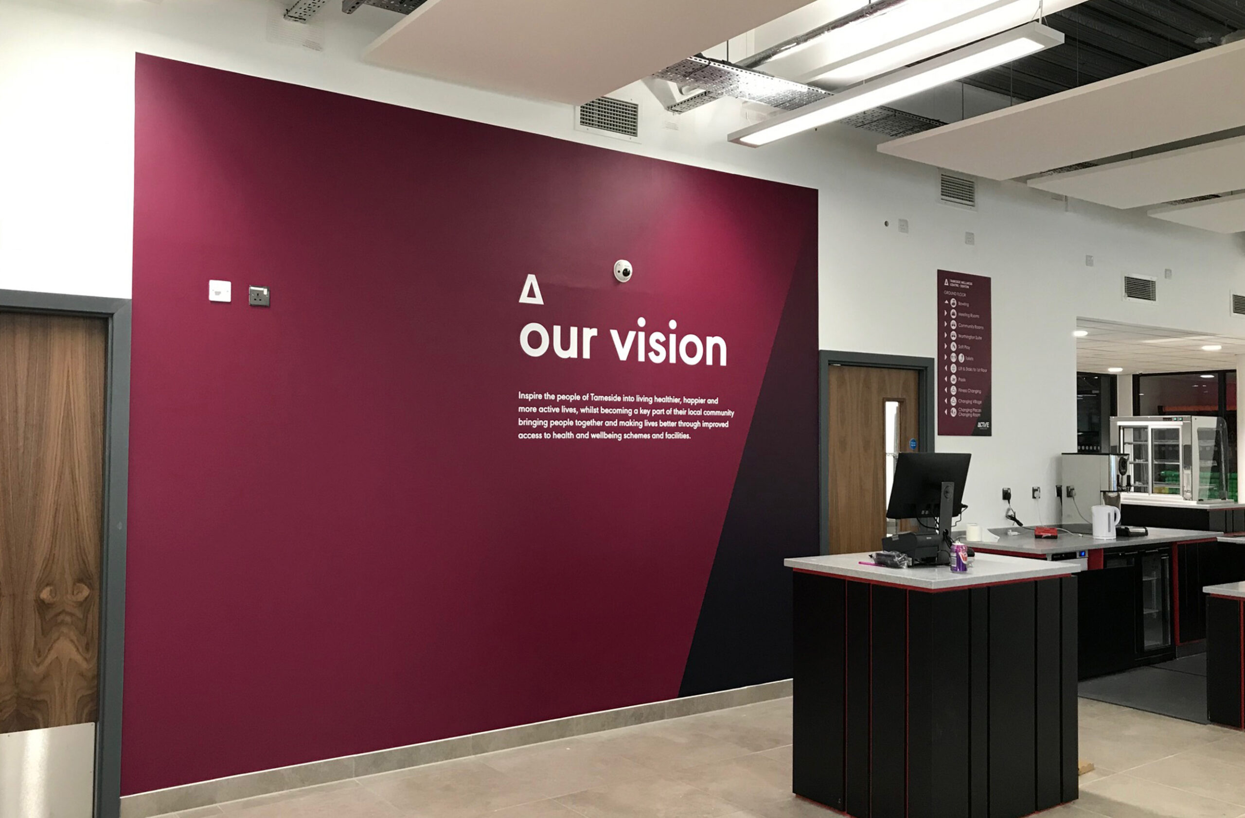 Large reception wall graphic displaying the companies vision